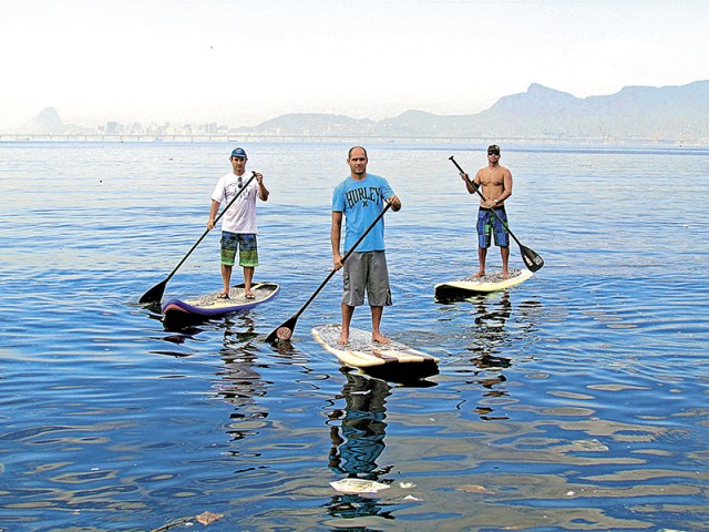 Em pé sobre a  prancha no mar e  com o auxílio do  remo, os praticantes curtem o esporte